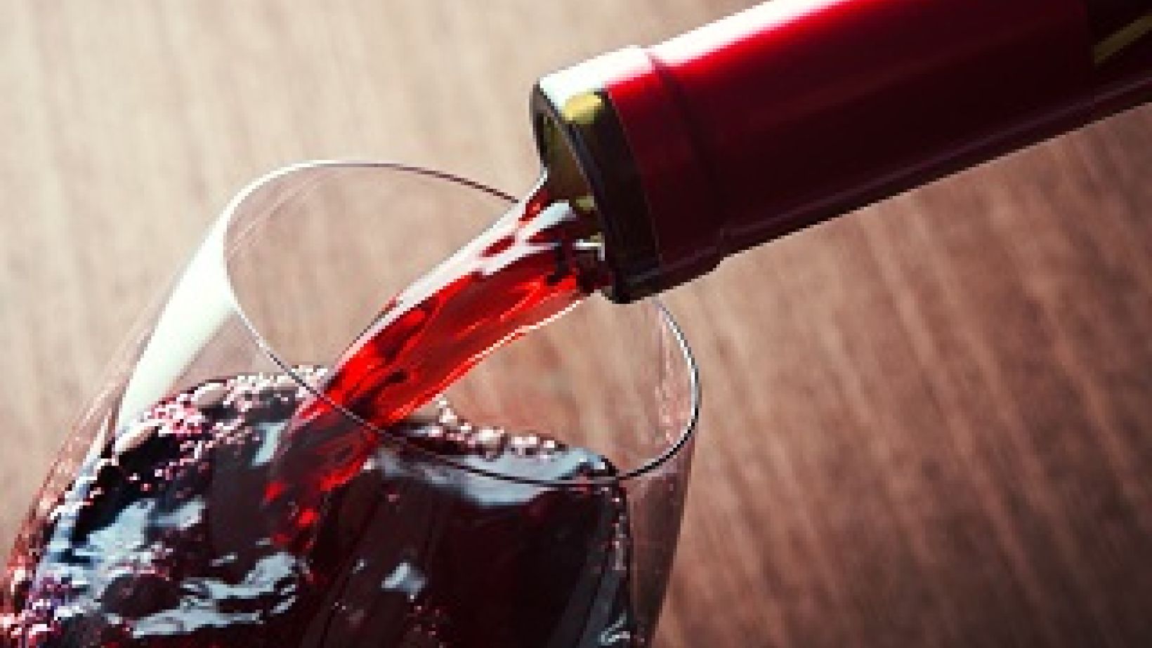 Closeup of red wine pouring in glass