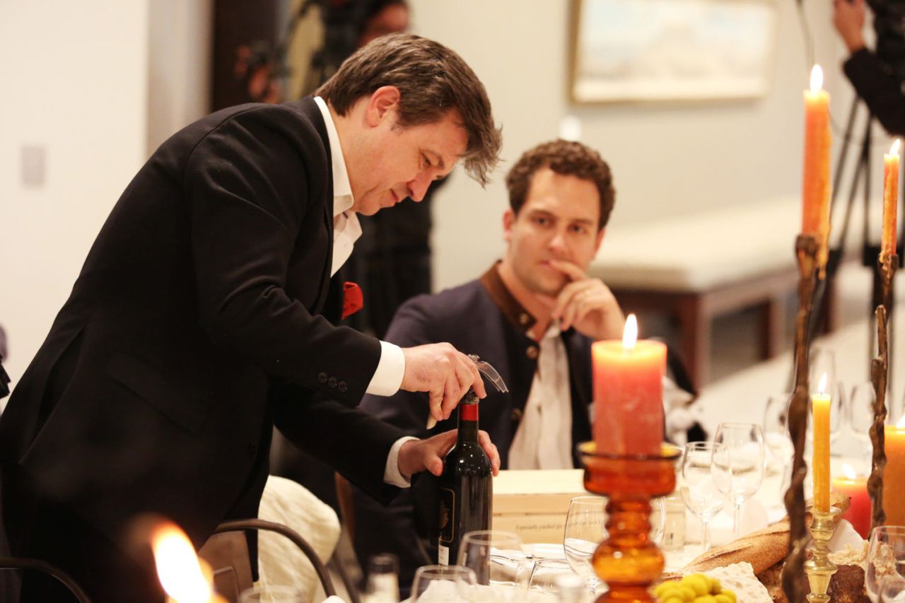 Sommelier Jean Vincent Ridon opens the charity lot of Chateau Palmer for buyer Nicolo Pudel