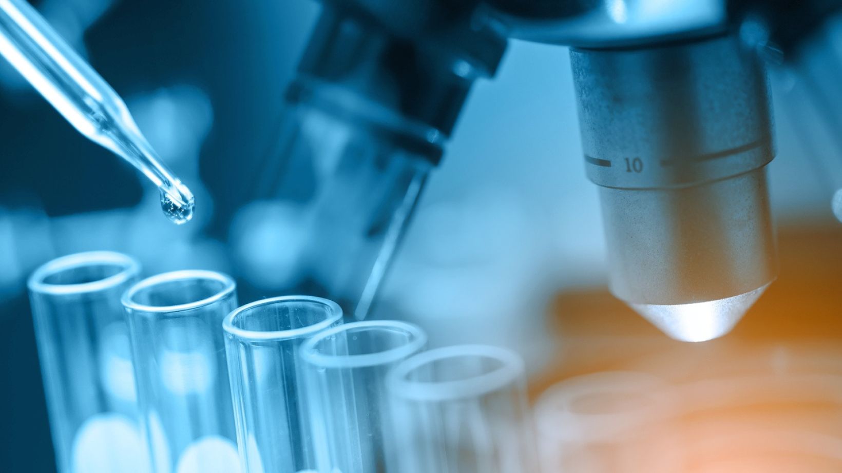 microscope with lab glassware, science laboratory research and development concept