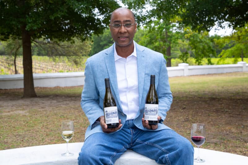 SOLMS CEO Tommy Hall, with the first two official wines released by the Solms-Delta Wine Company.